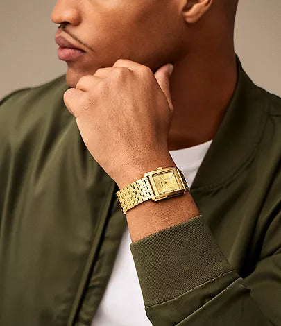 Fossil Carraway FS6009 gold-tone watch worn on wrist