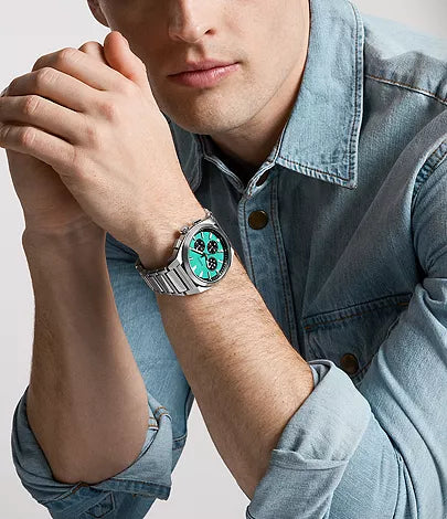 Fossil Everett watch worn on model's wrist with denim shirt