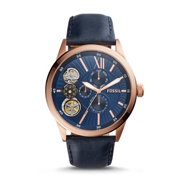Fossil Flynn mechanical watch with rose gold case, navy blue dial, skeleton detail, and navy leather strap