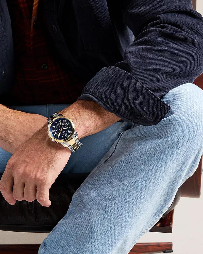 Fossil Grant chronograph on wrist, two-tone stainless steel band, blue dial
