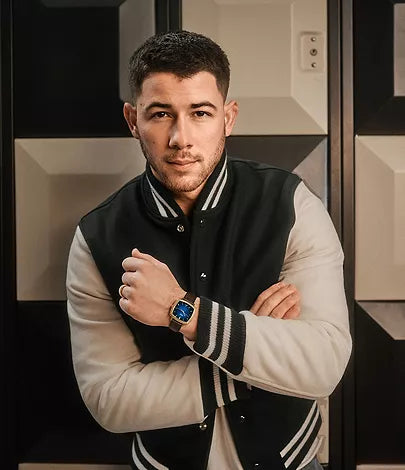 Nick Jonas wearing gold-tone Fossil Machine Luxe watch with blue dial