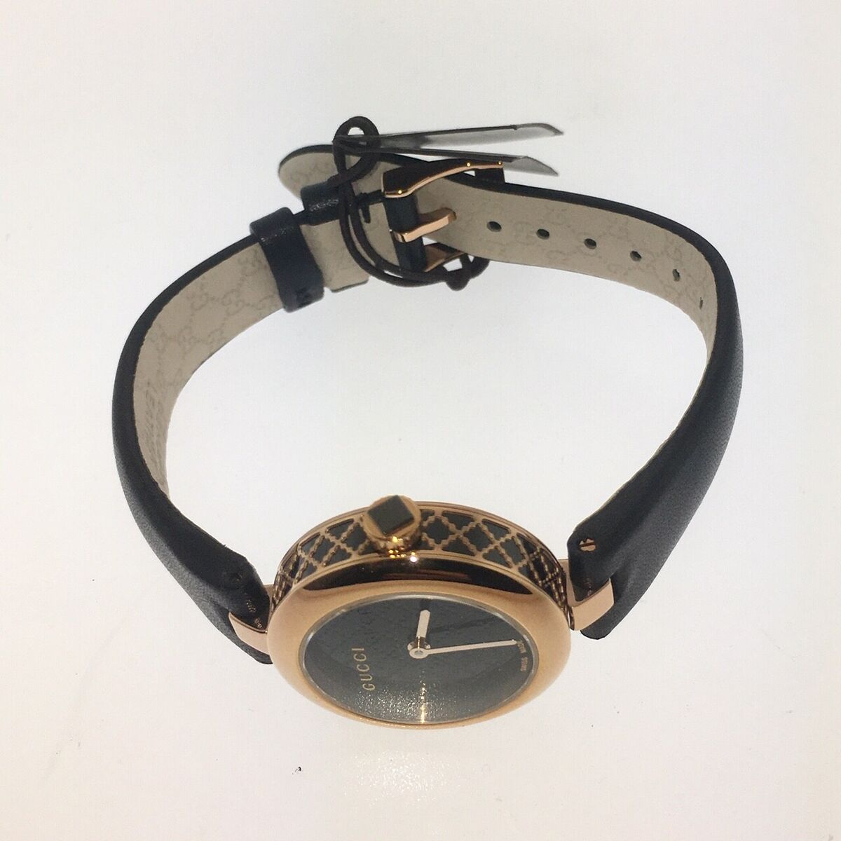 Gucci Diamantissima watch worn on wrist showing black leather strap and buckle closure