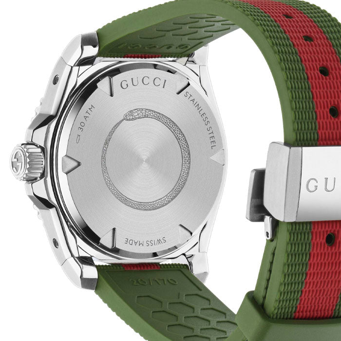 Caseback of Gucci Dive watch showing stainless steel with engraved text and green-red strap