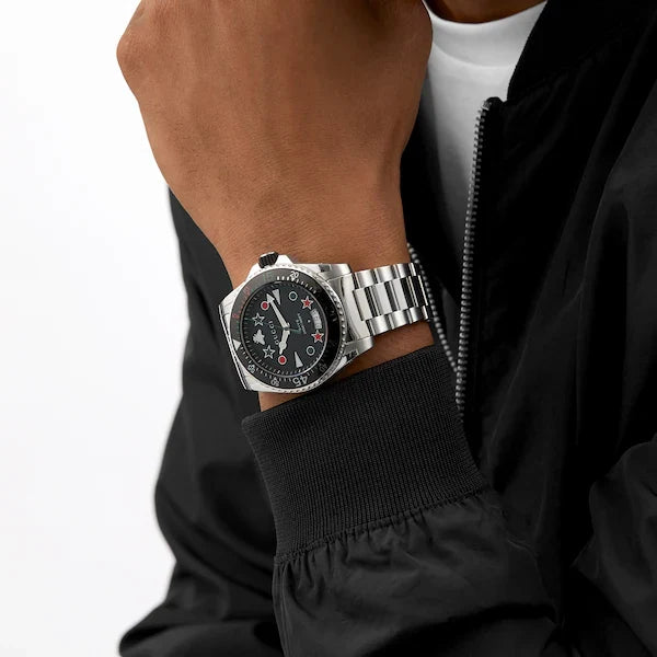 Gucci Dive 45mm watch on wrist showing dial and stainless steel bracelet fit