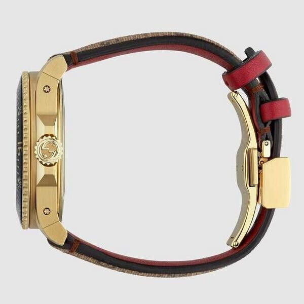 GUCCI Dive Doraemon watch side view displaying gold case, canvas and red leather strap, fold-over clasp