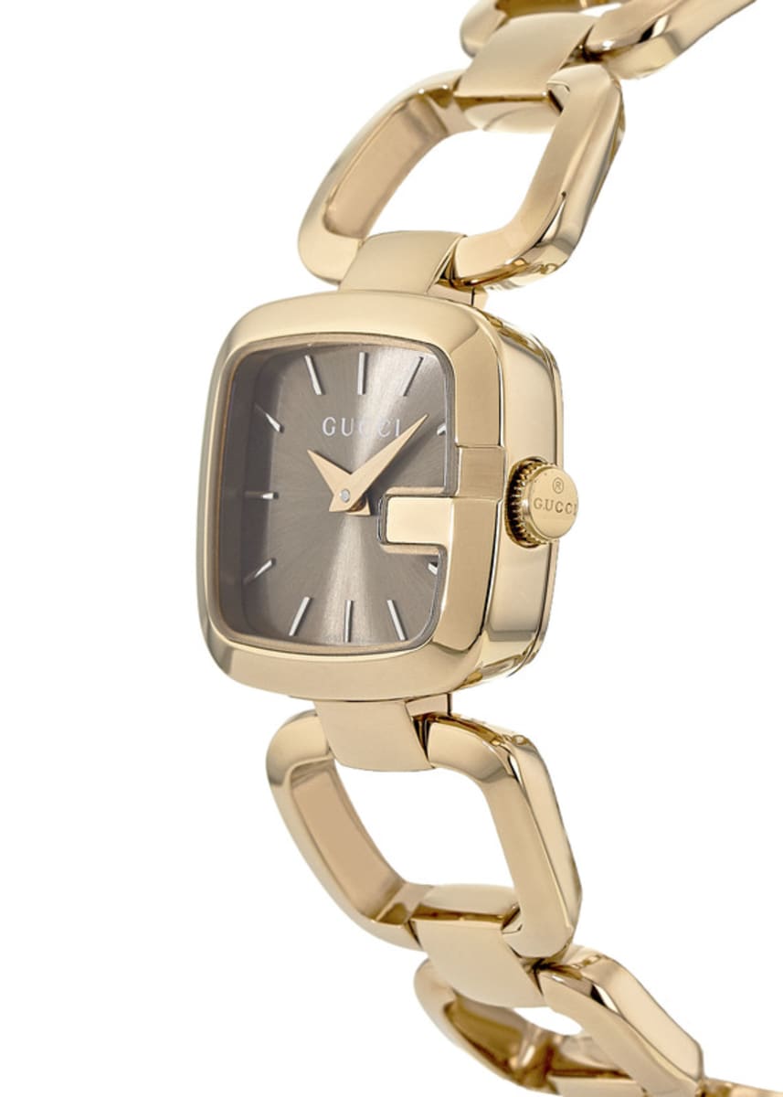 Angled view of Gucci G-Gucci watch showing gold-tone case, brown dial, and link bracelet