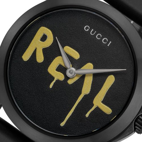 Gucci G Timeless Ghost dial detail showing REAL text and watch hands closeup