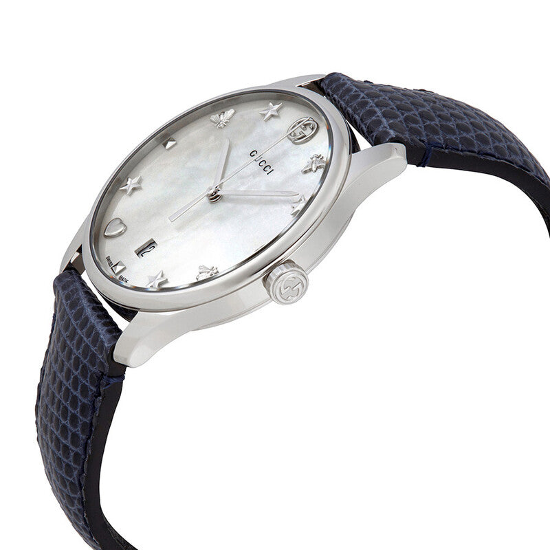 Gucci G-Timeless watch shown at angle with mother of pearl dial and blue quilted leather strap