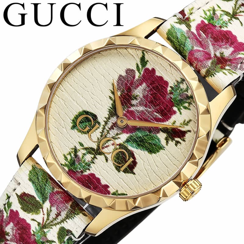 Gucci G Timeless watch worn showing floral dial and white leather strap detail