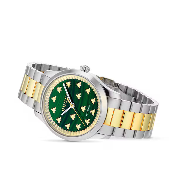 Gucci G-Timeless watch three-quarter view showing malachite dial with bee motifs and steel gold bracelet