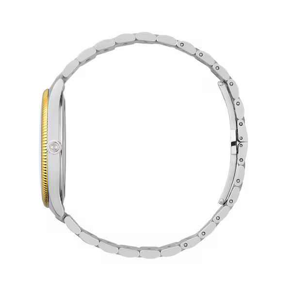 Side profile of Gucci G-Timeless watch showing gold bezel and bracelet depth