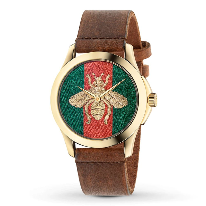 Gucci G Timeless watch three-quarter view showing gold case and brown leather band