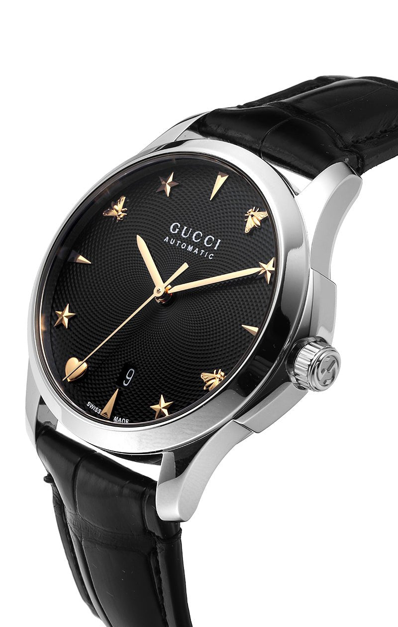 Gucci G-Timeless watch at three-quarter angle showing stainless steel case and black leather strap