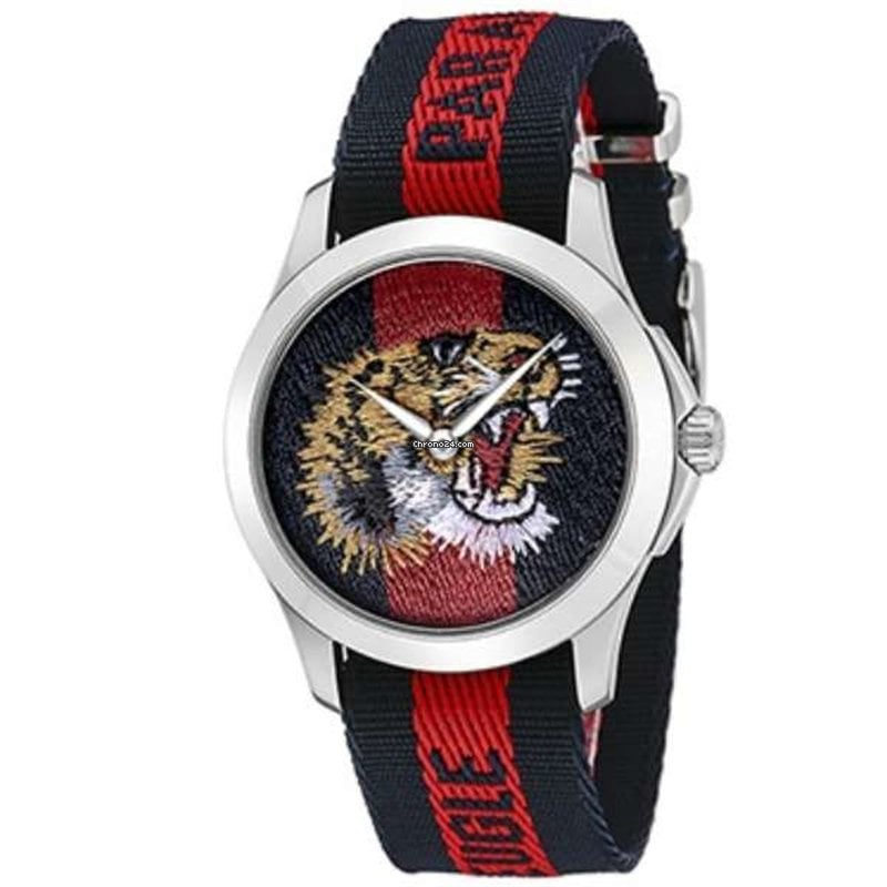 Gucci G Timeless tiger watch angled view showing white case and striped nylon strap