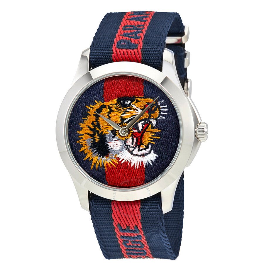 Gucci G Timeless watch front view with embroidered tiger motif on dial and red stripe strap
