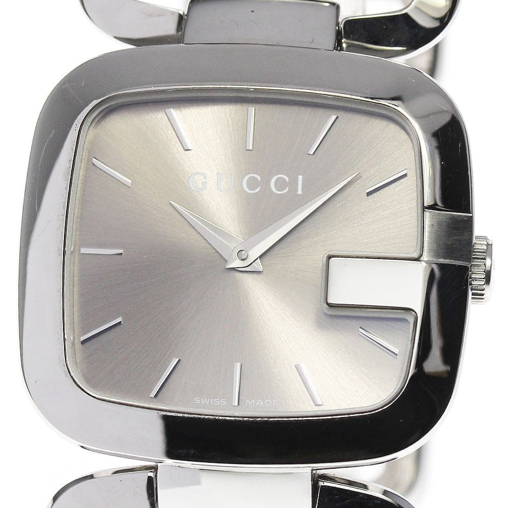 Dial-close-up of Gucci G square watch with brown face and silver hour indexes