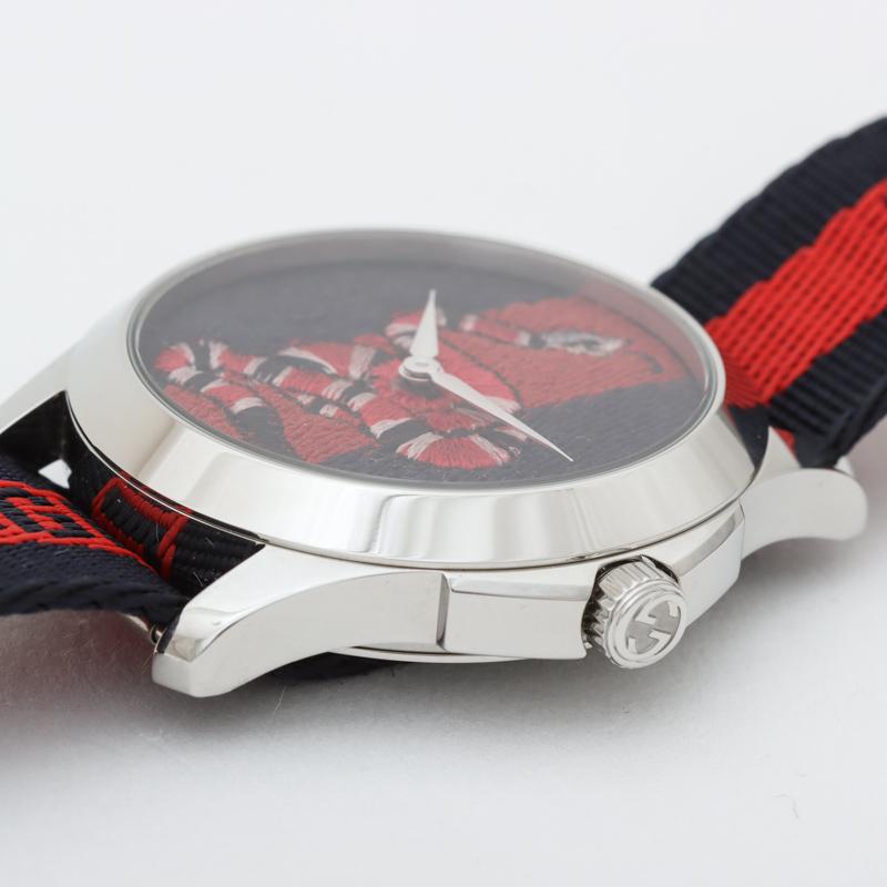 Gucci Le Marche Des Merveilles dial close-up detail of red and black embroidered serpent motif