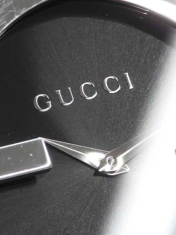 Close-up of Gucci Interlocking G black dial with GUCCI text