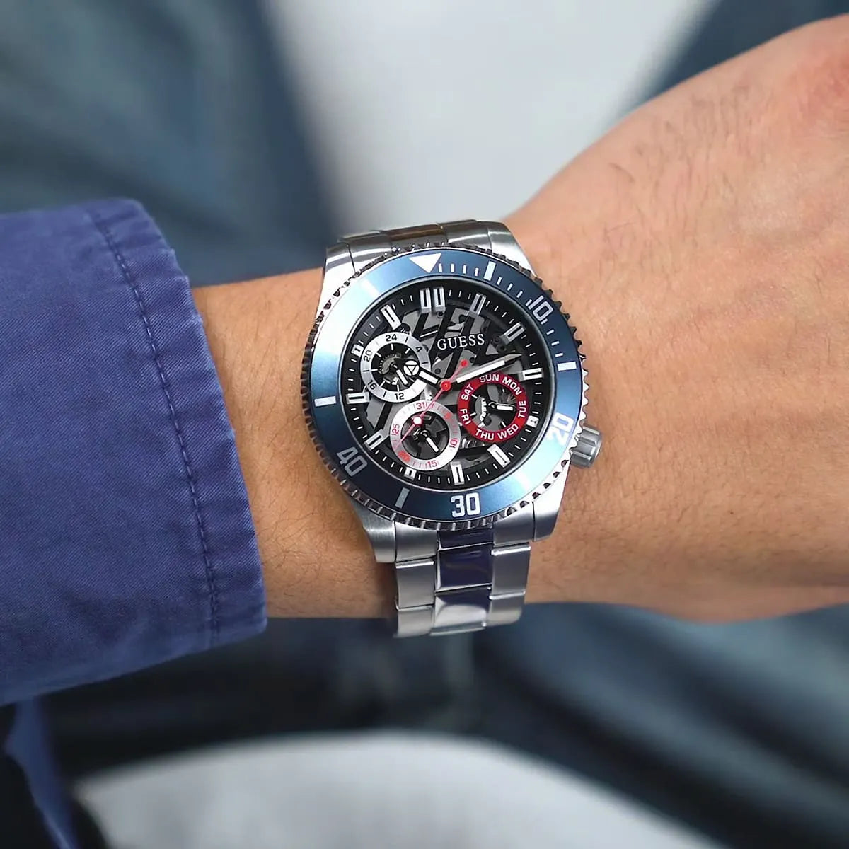 GUESS Axle GW0488G1 watch worn on wrist with blue dial visible