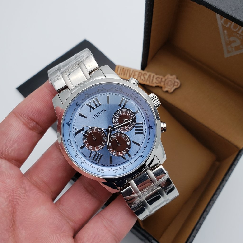 Guess Chrono blue dial watch in hand with product packaging