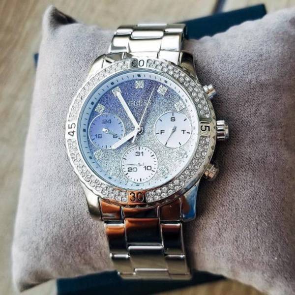 Guess Confetti Crystal watch on wrist showing blue and white chronograph dial