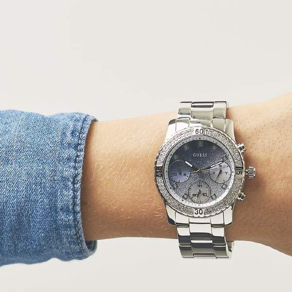 Guess Confetti Crystal ladies watch worn on wrist with denim sleeve