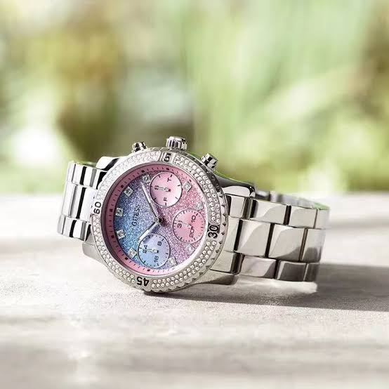 Guess Confetti ladies watch angled view showing crystal-studded bezel and three-link band