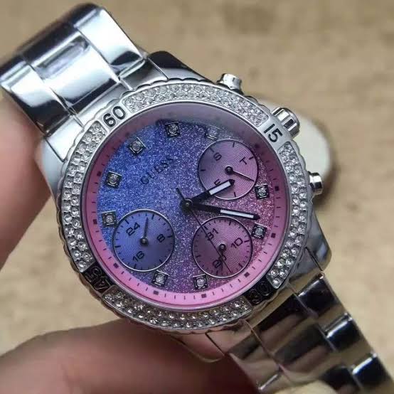 Close-up of Guess Confetti dial with pink and blue gradient, chronograph subdials, and crystal bezel