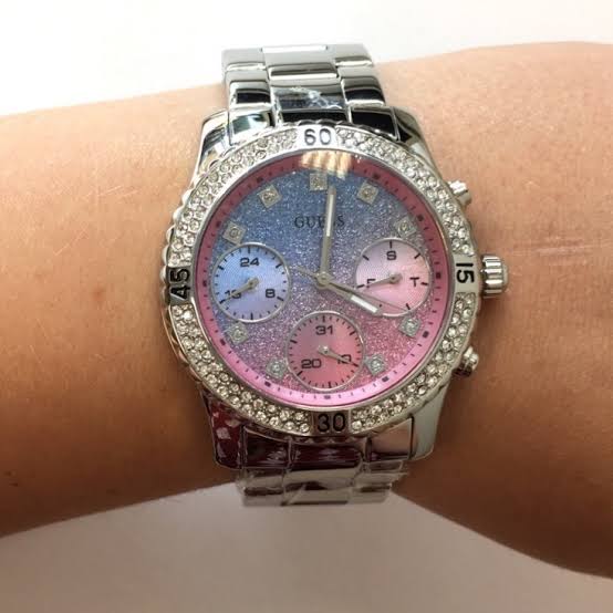 Guess Confetti ladies watch on wrist showing silver-tone three-link band and chronograph dial