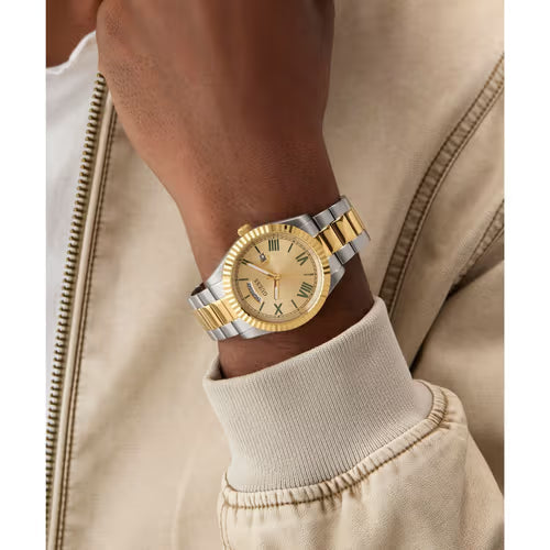 GUESS Connoisseur watch on wrist showing champagne dial and two-tone bracelet detail
