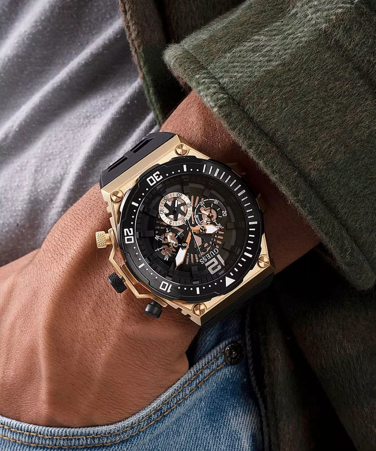 GUESS Exposure GW0325G1 gold and black chronograph watch worn on wrist