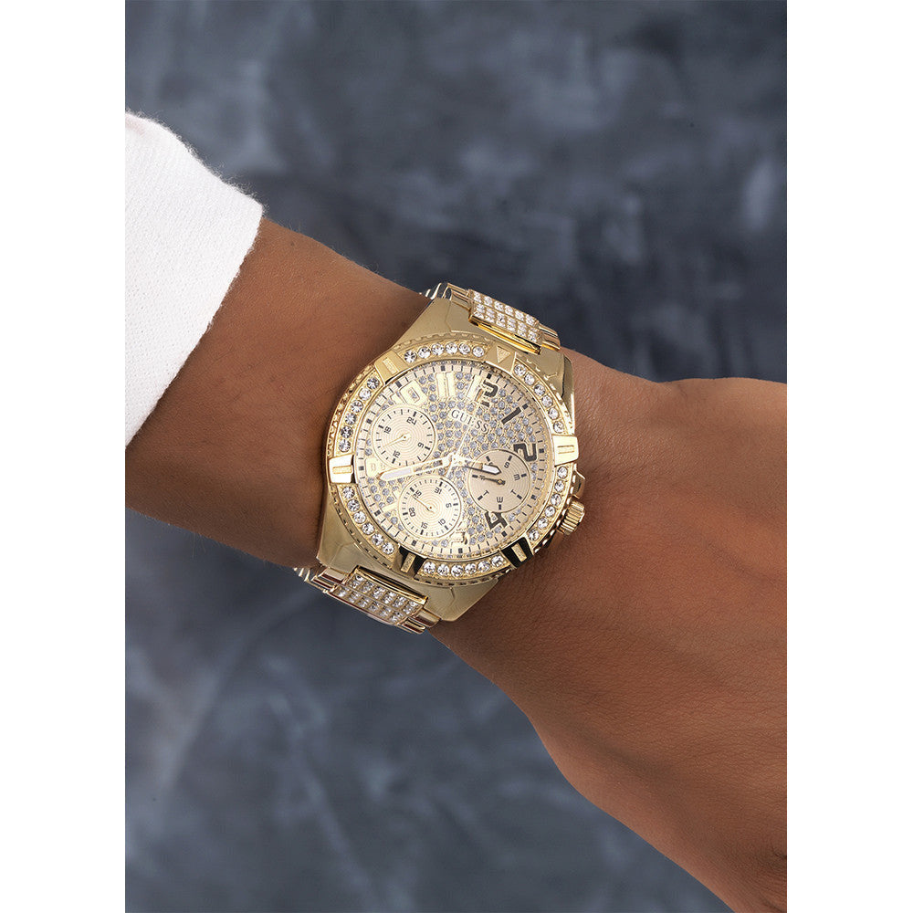 Guess Frontier Crystal watch worn on wrist, gold-tone with crystal details