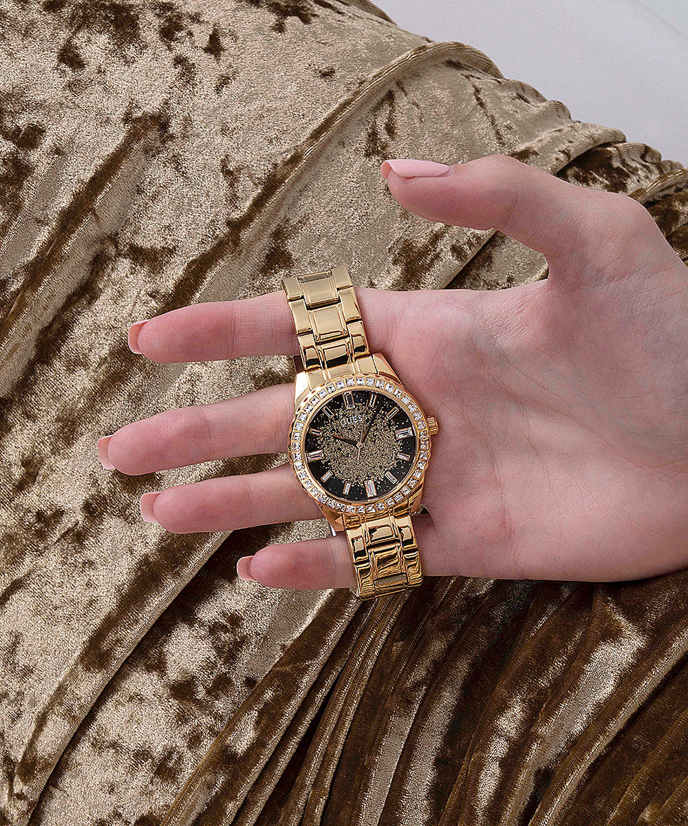 Guess Glitter Burst gold tone watch worn on wrist showing glitter dial detail