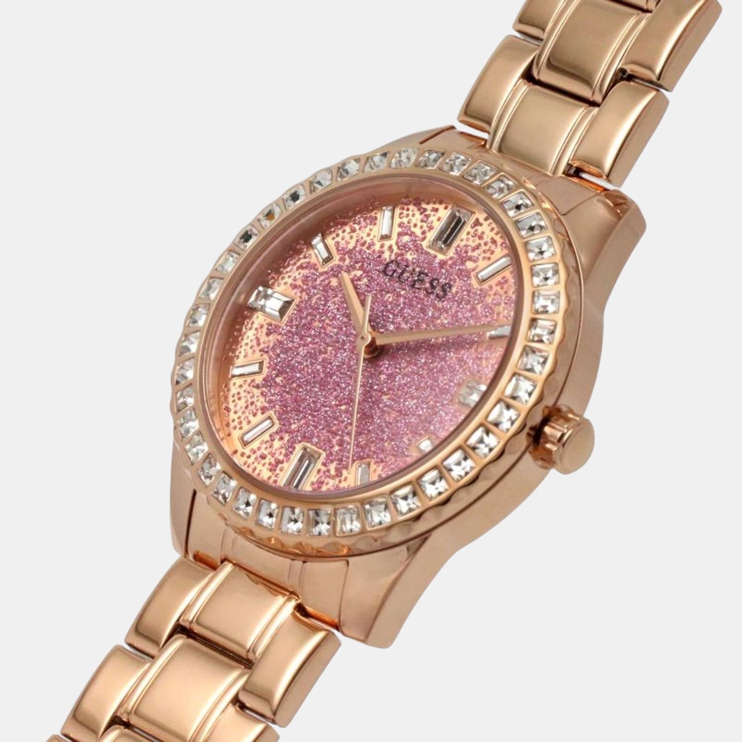 Angled view of Guess Glitter Burst rose gold watch with glitter dial and crystal bezel detail