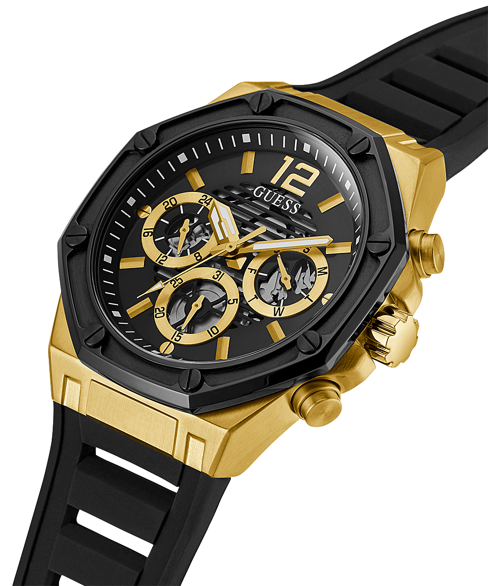Angled view of Guess men's watch showing gold-tone case with black silicone strap and chronograph subdials