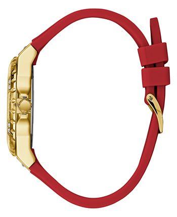 Guess women's watch side view showing gold tone case and red silicone strap with buckle