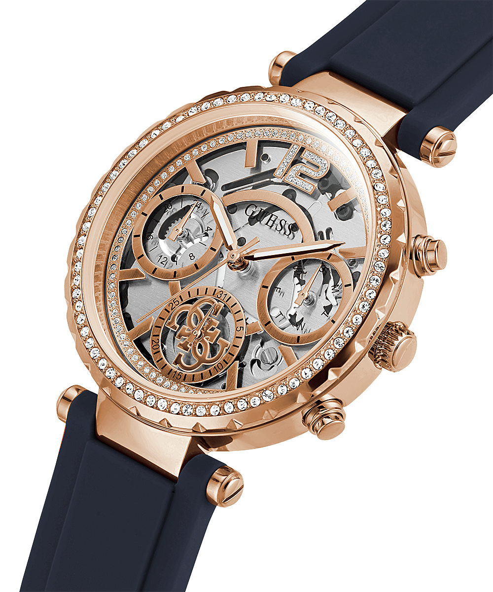 Guess rose gold chronograph watch with skeleton dial and navy rubber strap, angled view