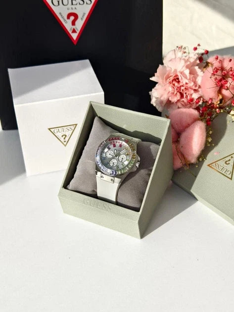 Guess GW0541L1 watch displayed in branded white box with Guess logo and pink flowers
