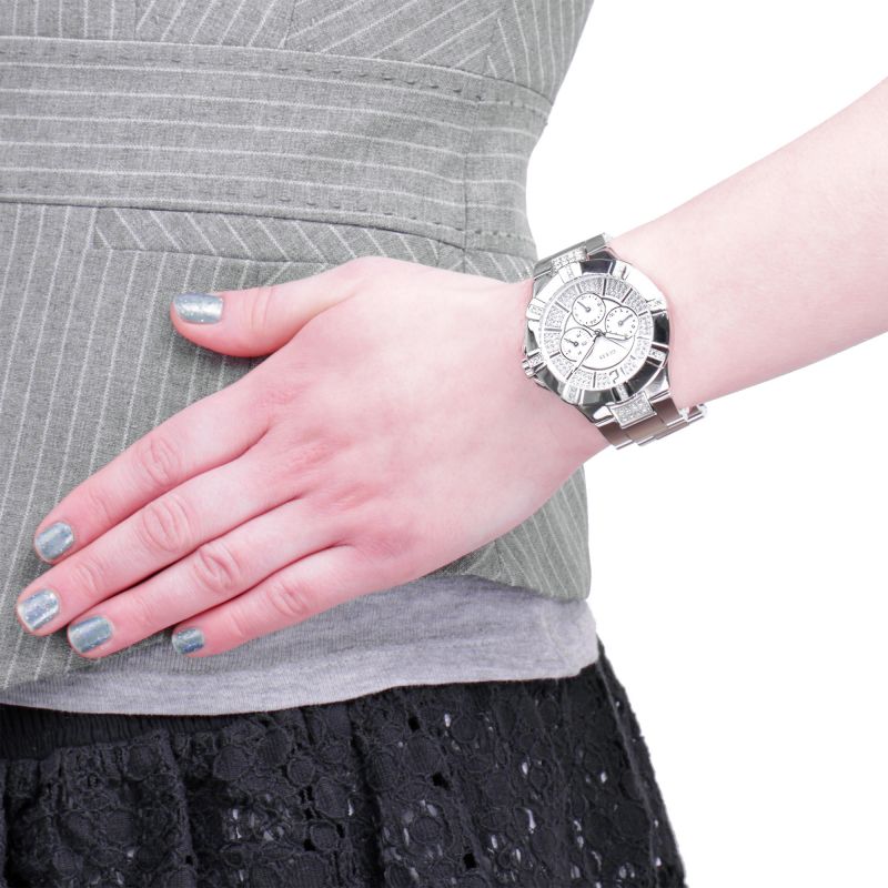 On-wrist lifestyle shot of Guess Vista watch with silver-tone bracelet