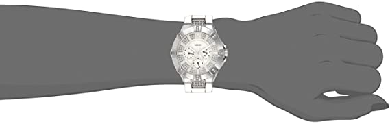 Guess Vista watch worn on wrist, featuring silver-tone case and crystal dial