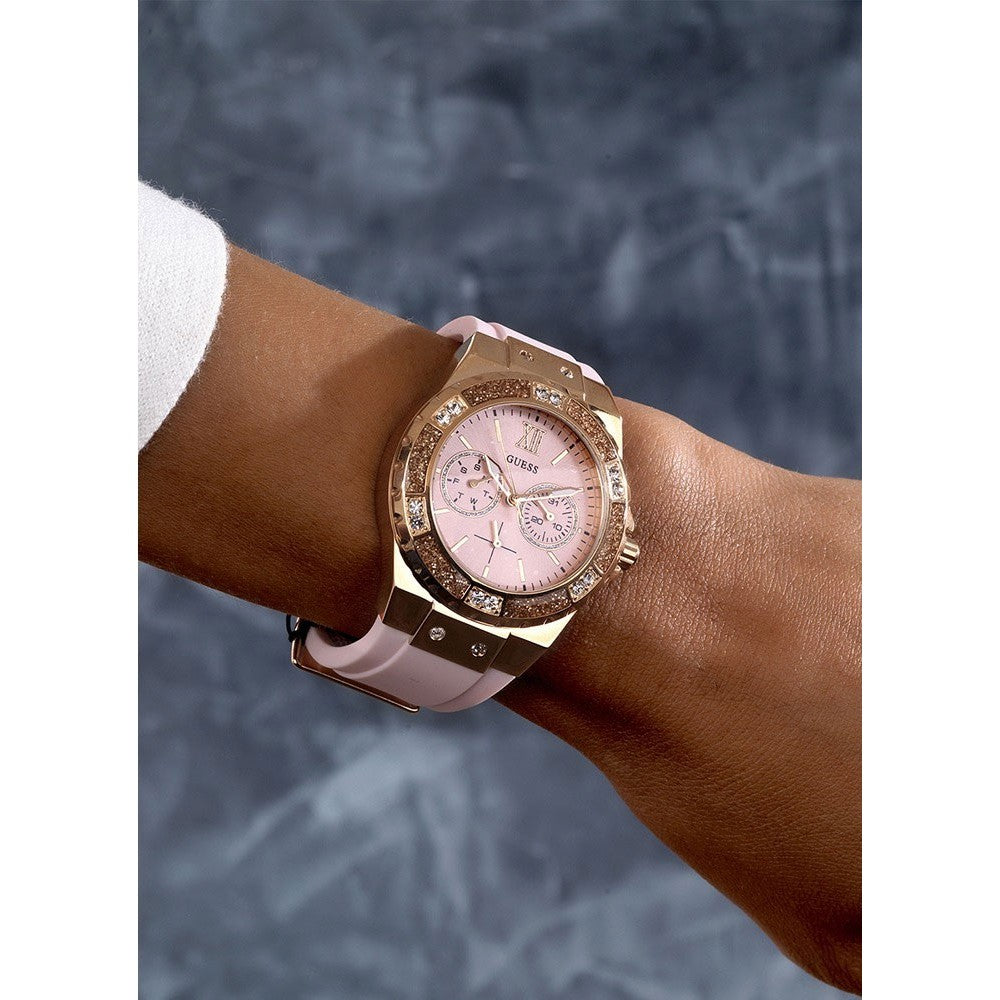 Guess Limelight watch worn on wrist showing pink dial, rose gold bezel, and crystal accents