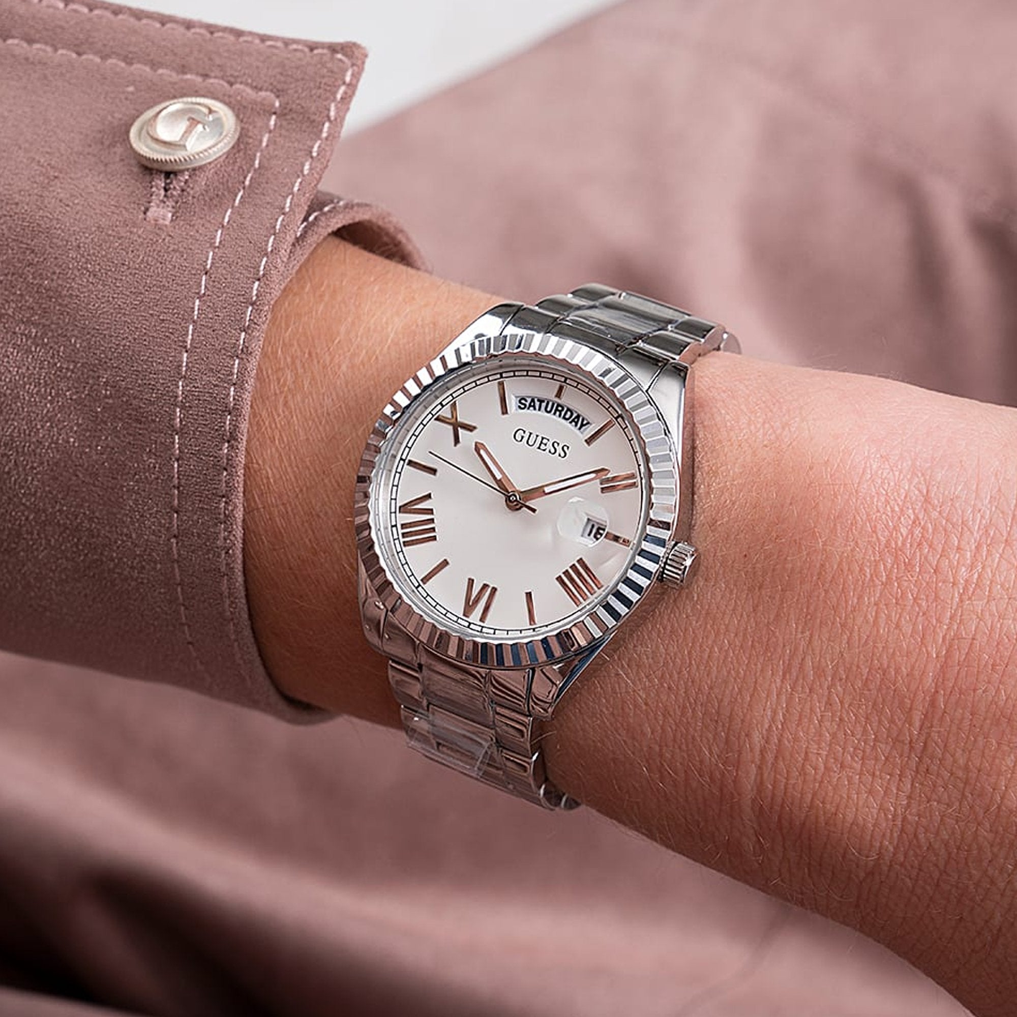 Guess Luna watch worn on wrist with silver case and bracelet on white dial