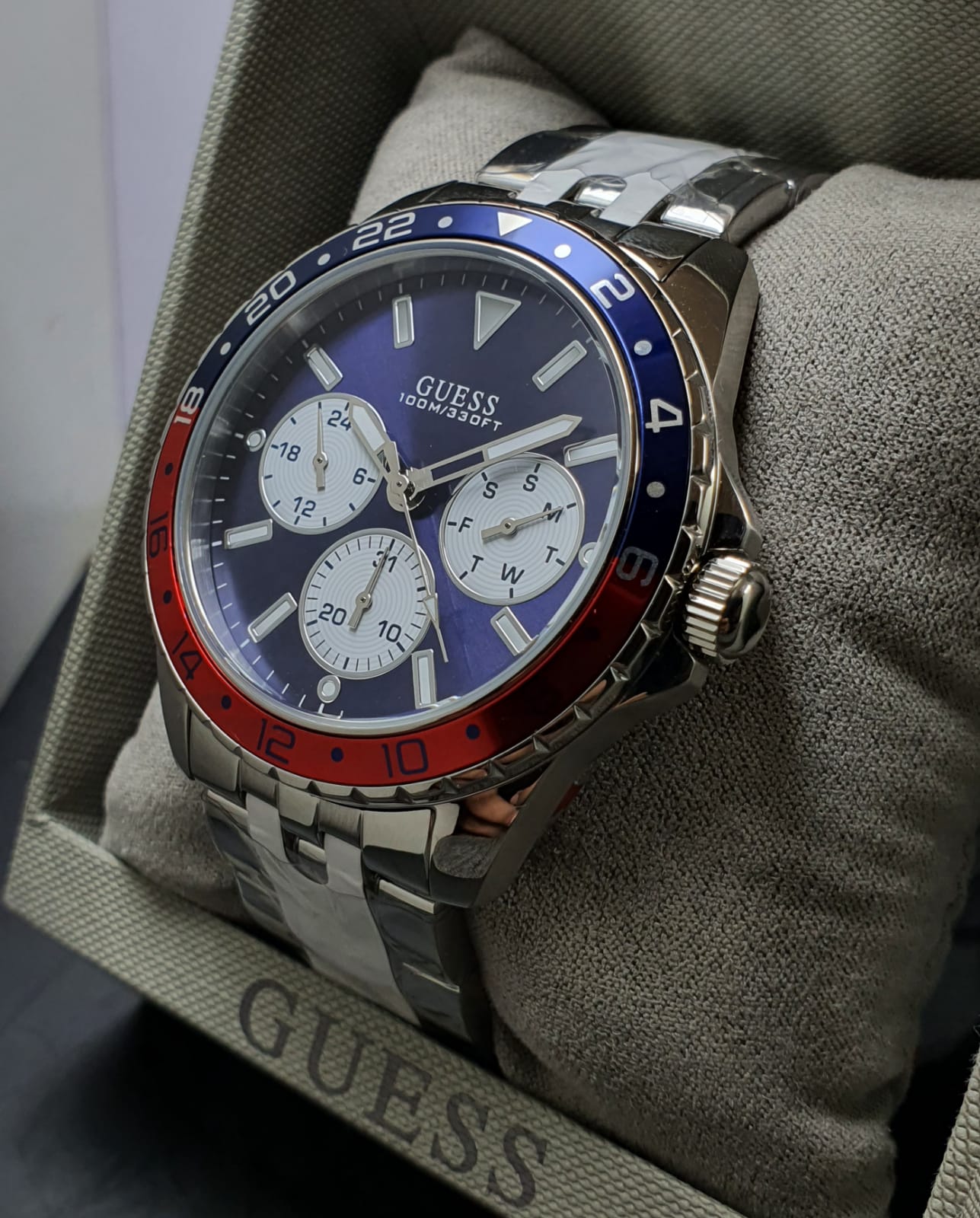 Guess Odyssey chronograph watch on wrist showing blue dial and pepsi bezel
