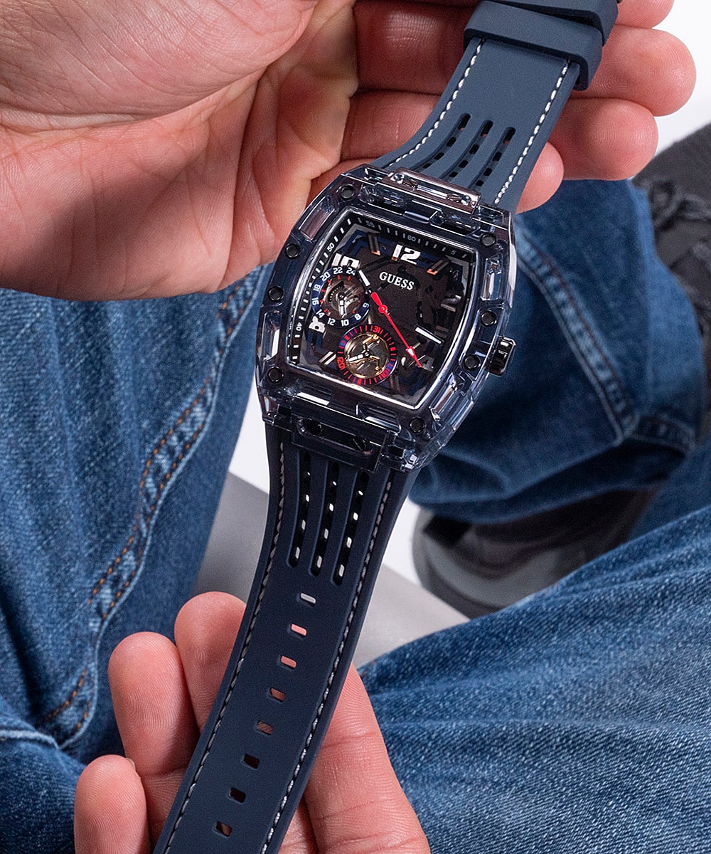 Guess Phoenix watch worn on wrist showing navy skeleton dial and silicone strap