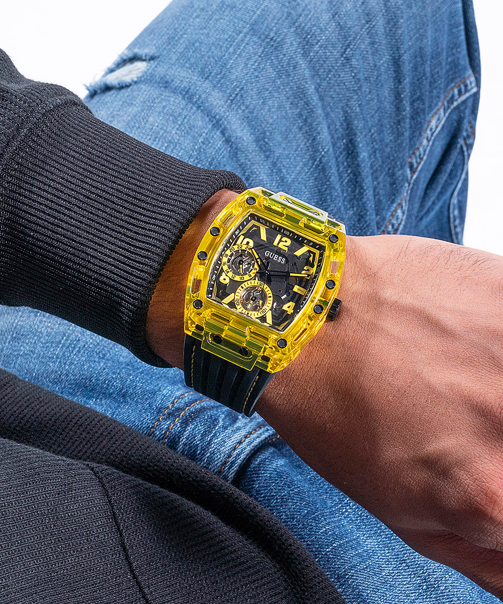 Guess Phoenix watch worn on wrist with yellow case and black silicone strap