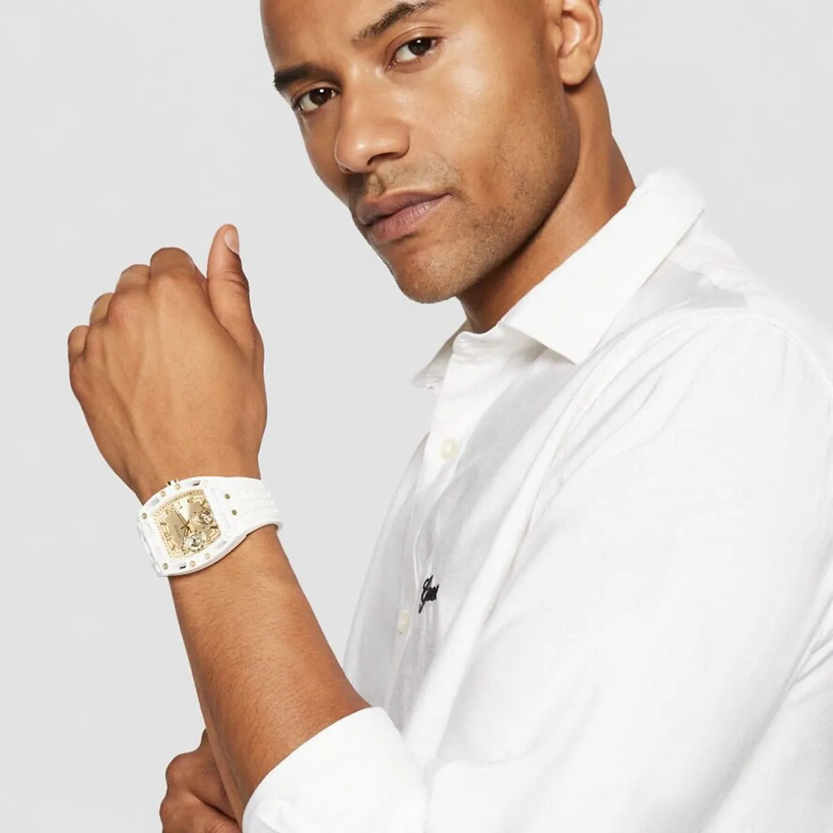 Man wearing Guess Phoenix white and gold watch with white button-up shirt
