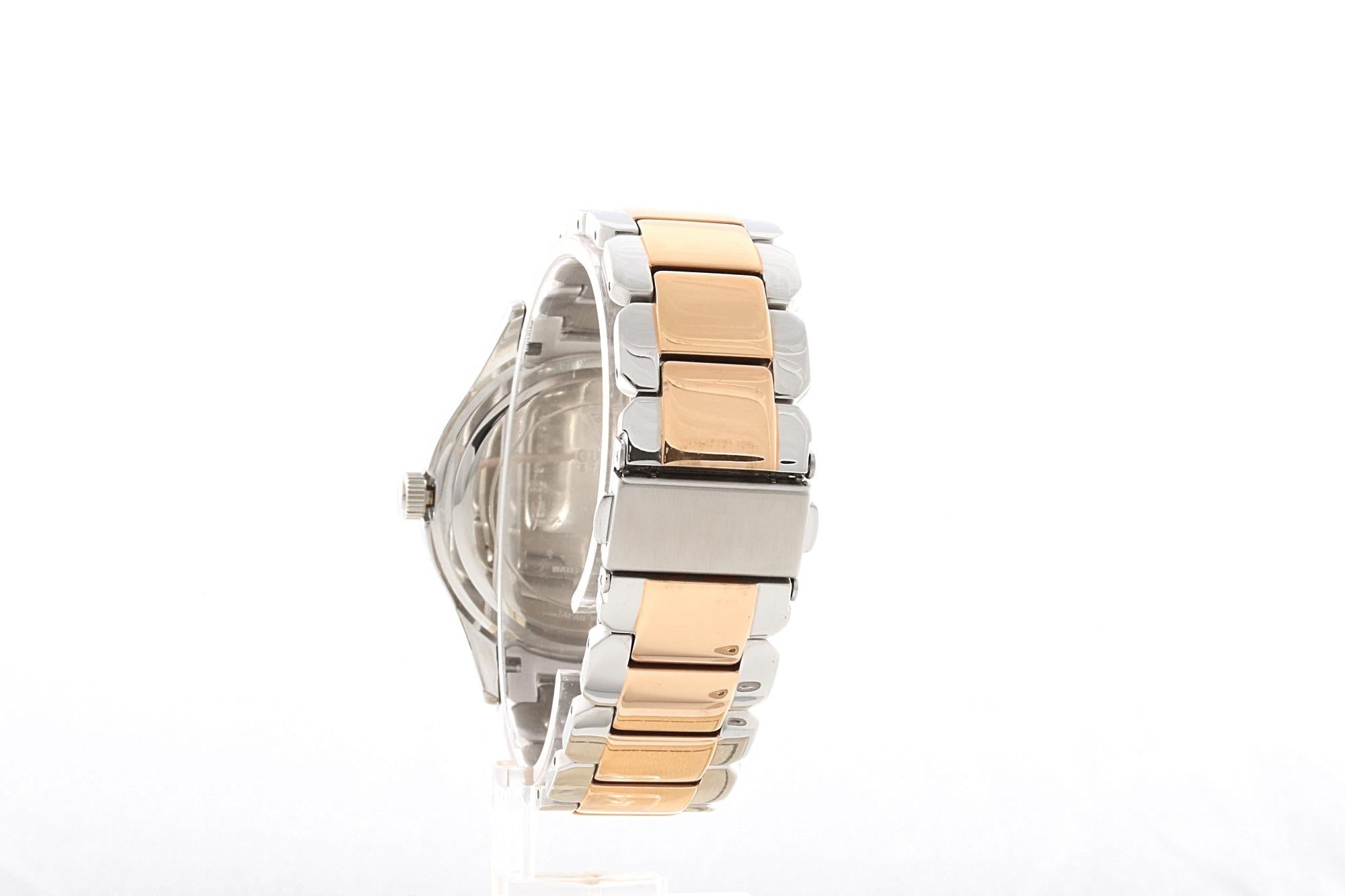 Side view of Guess Siren two-tone watch showing case depth and bracelet profile