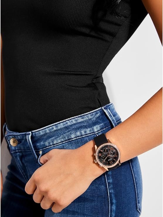 Guess Solar chronograph watch worn on wrist, showing rose gold case and black dial on woman