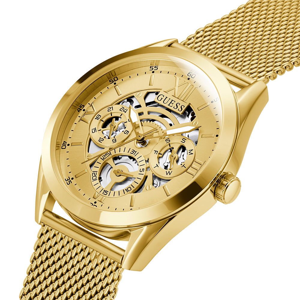 Angled view of Guess Tailor watch showing gold mesh strap and skeletal dial