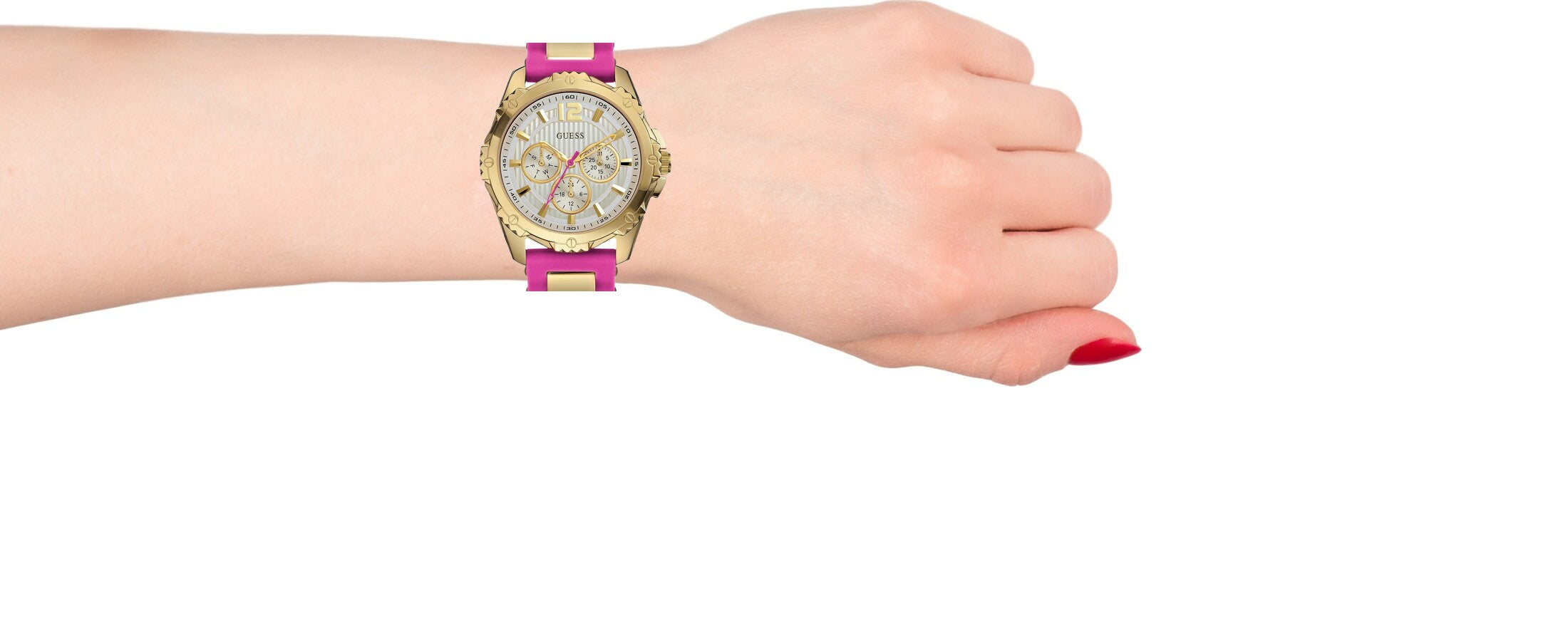 Guess pink and gold women's watch with silicone strap worn on wrist